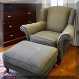F41. Green uphostered chair and ottoman. Tears in upholstery. - $65 
